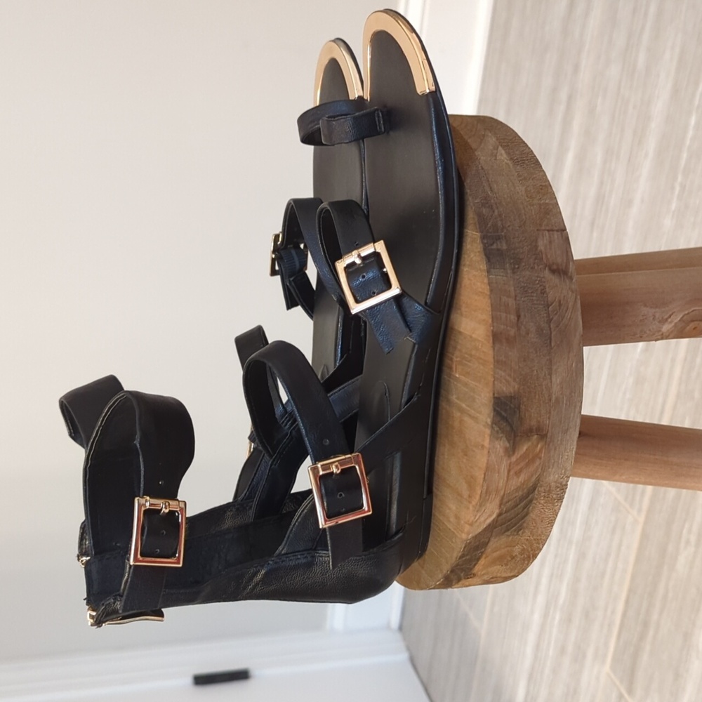 BCBG Generation Black Leather and Gold Gladiator Sandals